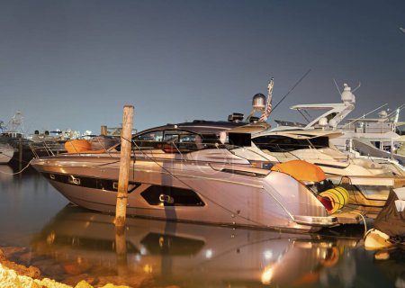 Voyage is waiting. Luxury yacht in Miami, USA. Yacht berth at dusk. Sea boat at moorage in evening. Seaside holidays. Summer vacation.