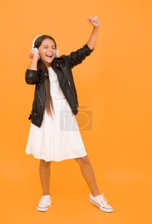 Photo for This is my day. future pop star. child enjoying rhythms. be creative and active. full of energy. happy kid singing. listen to music. little girl with headphones. child having fun. childhood happiness. - Royalty Free Image