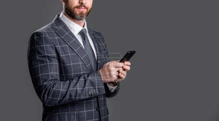 Photo for Business man chat on smartphone in suit, copy space. business man chat on smartphone isolated on grey. business man check smartphone chat in studio. photo of business man chat on smartphone. - Royalty Free Image