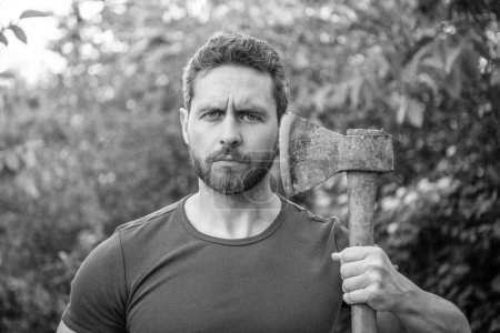 mature bearded masculine guy with axe. masculine guy with axe outdoor. photo of masculine guy with axe. masculine guy with axe.