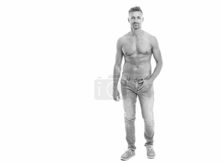 A man with physique poses shirtless showing muscular torso, copy space banner. muscular man with torso isolated on white. man with muscular torso. fit and muscular man shows abs and torso in studio.