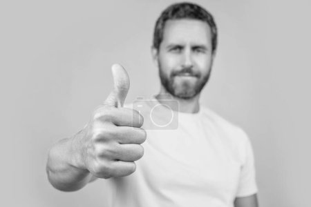 selective focus photo of man approve with thumb up. man approve isolated on yellow. man approve on background. man approve in studio.