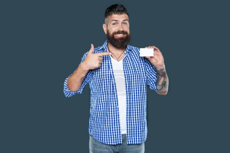 glad bearded man showing blank debit card with copy space.