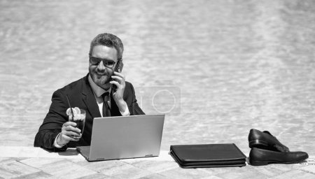 freelancer working online has phone call with laptop, advertisement. photo of freelancer working online has phone call. freelancer working online has phone call. freelancer working online