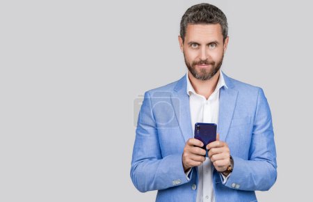 Photo for Business communication. Casual business man chatting on phone isolated on grey. Voice message. Businessman using phone. Man phone conversation in studio. Middle aged hispanic business man with phone. - Royalty Free Image