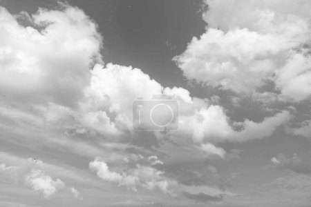 background of blue sky with white clouds in daylight.