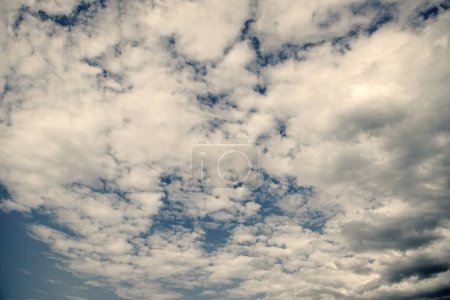blue sky background with white fluffy clouds.