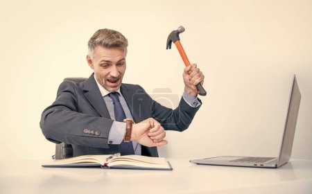 shocked boss hitting laptop with hammer and checking time.