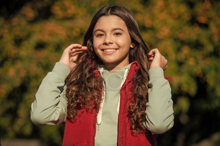 positive teen girl portrait in sunny day. portrait photo of curly teen girl. teen girl portrait outdoor. curly teen girl portrait outside.