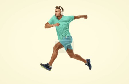 active sportsman jogger running. The sportsman running at full speed towards the finish line. sportsman runner running isolated on white. Man sportsman running for exercise in studio.