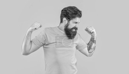 portrait of brutal man with beard show strength on background. portrait of brutal man with beard. portrait of brutal man with beard isolated on yellow. portrait of brutal man with beard in studio.
