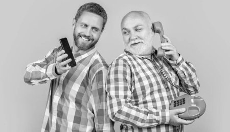 happy men with vs technology isolated on yellow. happy men with vs technology in studio. men with vs technology on background. photo of men with vs technology phone and telephone.