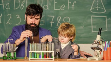 Educational school program. Teacher and child test tubes. School lesson. Perseverance pays off. Chemical experiment. Symptoms of ADHD at school. Schoolboy cute child experimenting with liquids.