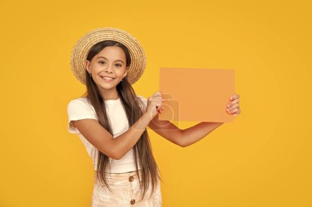 cheerful teen girl with copy space on orange paper on yellow background.