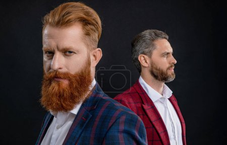Tuxedo men in menswear. Tuxedo men wear elegant jacket. Elegant men in formalwear. Elegance and style. Two businessmen at business event. Tuxedo men in elegant suit isolated on black. Redhead beard.