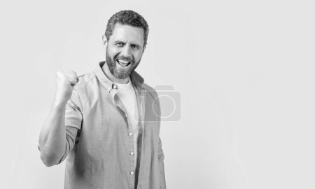 positive winning man win with yes gesture isolated on grey background. winning man win with yes gesture in studio. photo of winning man win with yes gesture. winning man win with yes gesture