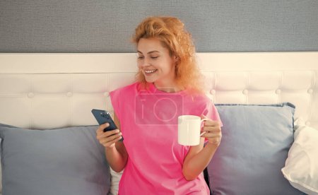 cheerful woman with coffee chat on phone. woman chat at home with phone. phone chat at home of woman.