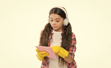 Make household more joyful. Have fun. Cleaning worries away. Everything in its place. Anti allergen cleaning products. Cleaning supplies. Let music move you. Girl headphones and gloves cleaning.
