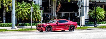 Photo for Miami Beach, Florida USA - April 15, 2021: red Chevrolet Camaro on the road, side view. - Royalty Free Image