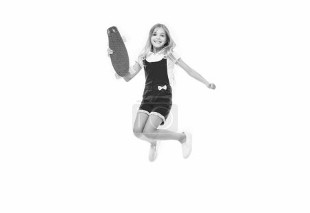 jumping teen girl skateboarding. teen girl skateboarding isolated on white. teen girl skateboarding in studio. teen girl skateboarding on background.