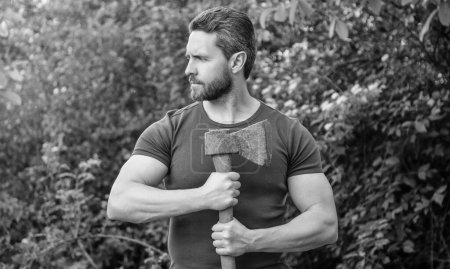 masculine man with ax outdoor. mature man with ax. man with ax. man with ax wearing shirt.