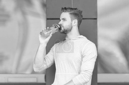 thirsty sportsman drink water bottle. thirsty sportsman with water outdoor. thirsty sportsman with water after training. thirsty sportsman with water.