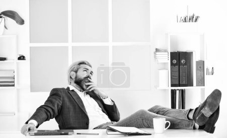 Working day. CEO has to be moral leader of company. Manager solving business problems. Businessman in charge successful business solutions. Developing business strategy. Man bearded boss sit office.