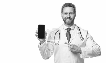 Photo for Medical man pointing finger telehealth on phone screen. medical man show telehealth isolated on white. medical man show telehealth in studio. medical man show telehealth on background. - Royalty Free Image