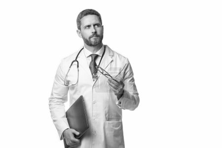 Photo for Pondering doctor presenting emedicine on background. emedicine and doctor man with laptop. doctor promoting emedicine isolated on white. doctor offering emedicine in studio. - Royalty Free Image