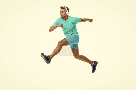sportsman runner running and jumping isolated on white. Man sportsman running for exercise in studio. sportsman jogger running. The sportsman running at full speed towards the finish line.