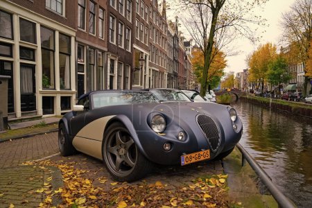 Photo for Amsterdam, Netherlands - November 15, 2021: Wiesmann GT MF5 roadster vintage convertible classic sport car parked at autumn river, corner view. - Royalty Free Image