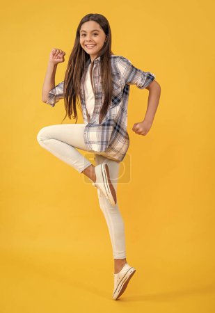 carefree stylish teenager girl. teen girl wearing checkered shirt. casual style of teenager girl. teen girl jumping. young and trendy. gen z. stylish shirt for everyday life. trendy student style.
