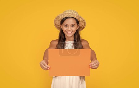 smiling teen child with copy space on orange paper on yellow background.