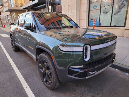 New York City, USA - March 29, 2024: 2022 Rivian R1T electric pickup truck car parked outdoor, angle view.