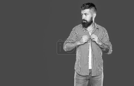 serious bearded man wear checkered shirt on grey background.