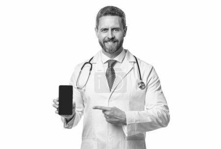 medical application. cheerful man doctor presenting medical phone application. emedicine in your phone.