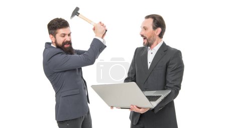 Thats the last straw. Angry businessmen hit laptop with hammer. De-stressing method. Bearded men got angry with computer problem. Stress relief in workplace. Feeling angry. Bad mood. Angry outburst.