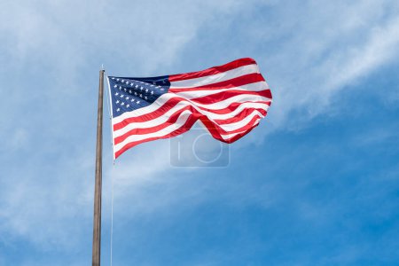 Independence day. Patriotic symbol. American Flag for Memorial Day or 4th of July. American flag waving in the wind. Flag of the USA. National waving flag of united states on blue sky. Labor day.