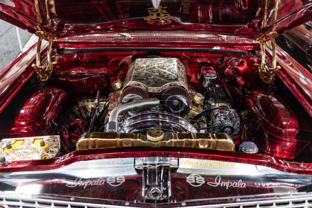 Photo for New York City, USA - March 27, 2024: Chevrolet Impala SS Chevy tuning car open hood with powertrain engine motor at New York International Auto Show, closeup. - Royalty Free Image