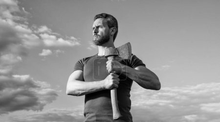 strong man with axe. caucasian man hold ax. brutally man on sky background.