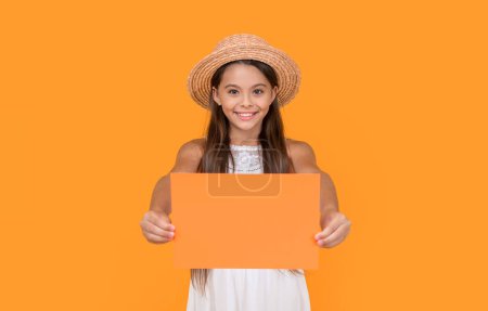 smiling teen child with copy space on orange paper on yellow background.