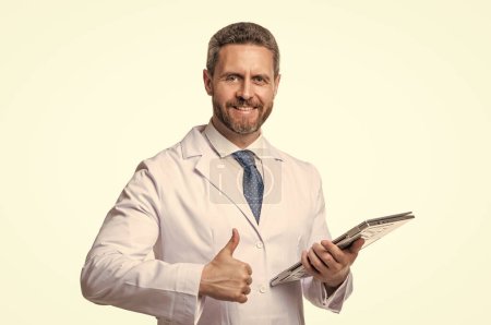 Photo for Happy man doctor giving thumbs-up.Telehealth doctor using tablet. Telehealthcare services. Ehealth. Telemedicine. - Royalty Free Image