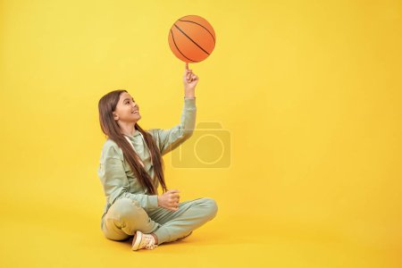 Skilled teen girl playing the basketball. Competitive teen girl playing basketball. teen girl practicing basketball skills. Teen girl excelling in basketball. Nurturing talent in childhood sports.