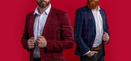Tuxedo men in menswear. Tuxedo men wear elegant jacket. Elegant men in formalwear. Elegance and style. Two businessmen at business event. Tuxedo men in elegant suit isolated on red. Cropped view.