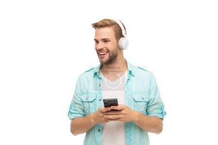 Man using smart phone application isolated in white. Listening music with phone. Music lifestyle. Audio playlist. Man in headphones. Man in headphones choosing playlist of mp3 on phone. Online blog.