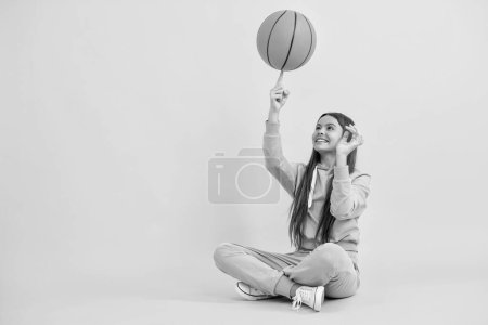 Teen girl excelling in basketball. Skilled teen girl playing the basketball. Competitive teen girl playing basketball. teen girl practicing basketball skills. Childhood sports achievements.
