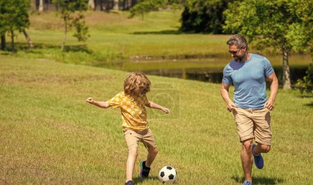 Father and child son teaming up outdoor. Father dad and son enjoying outdoor activities together. adventures between father and son. Active father son playing football in summer. soccer football.