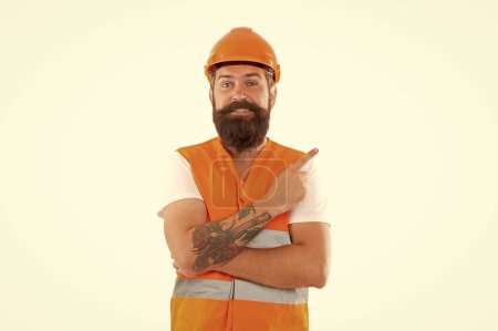 smiling bearded contractor in orange vest. studio shot of contractor wearing helmet. contractor isolated on white background. contractor man in uniform.