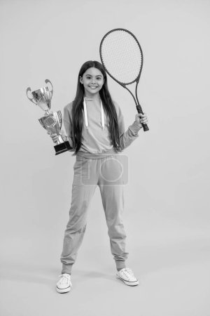 sport champion girl of badminton. girl celebrating as tennis tournament champion. skilled tennis champion. teen girl badminton player. teen girl champion on the tennis court. Badminton championship.