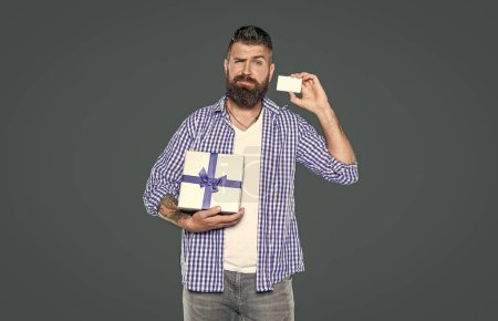 mature bearded guy with present box and card.